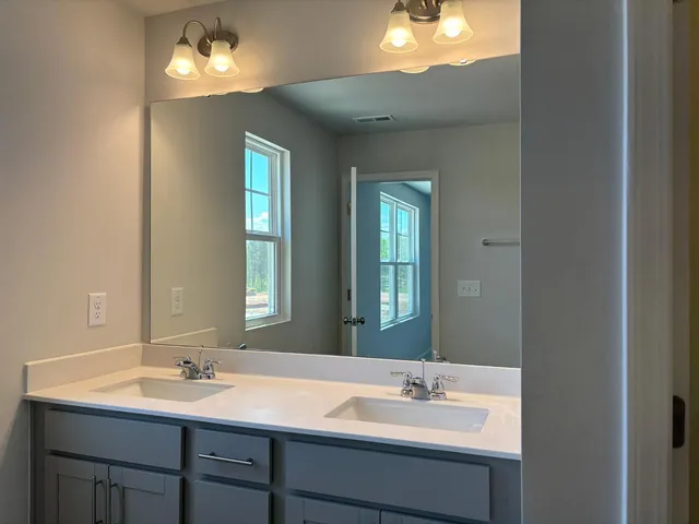 a bathroom with a double vanity sink and a mirror