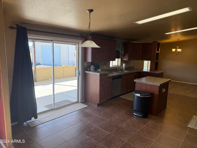 a kitchen with stainless steel appliances granite countertop a refrigerator and a stove