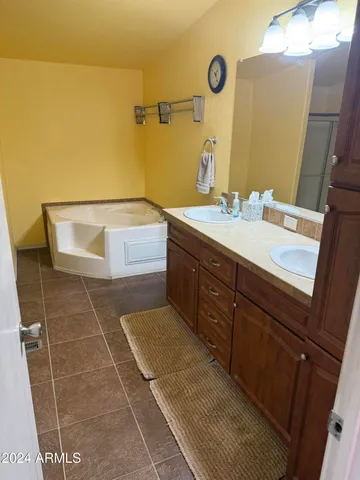 a bathroom with a granite countertop shower and a sink