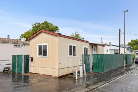 a view of a house with a small yard