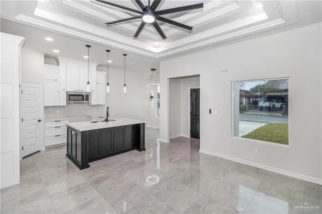 a kitchen with stainless steel appliances kitchen island granite countertop a refrigerator and a sink