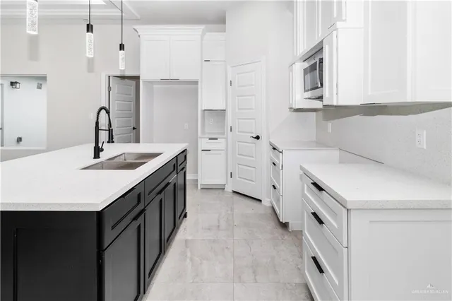 a kitchen with stainless steel appliances a sink stove and cabinets