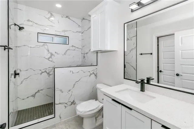 a bathroom with a sink toilet and shower