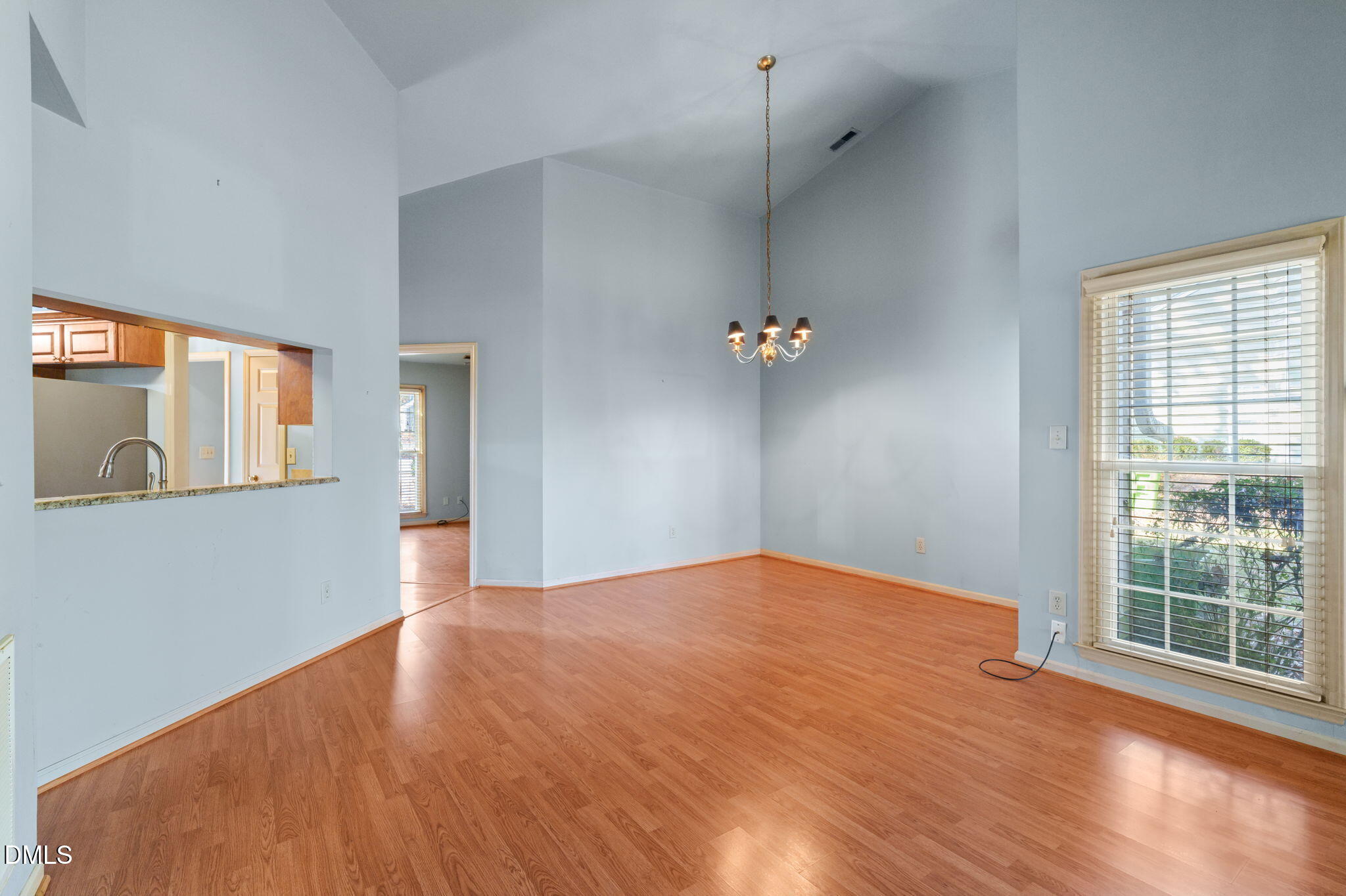 1212 Berley Court Raleigh, NC 27609 - Photo 11 of 38 a view of an empty room with a window and wooden floor