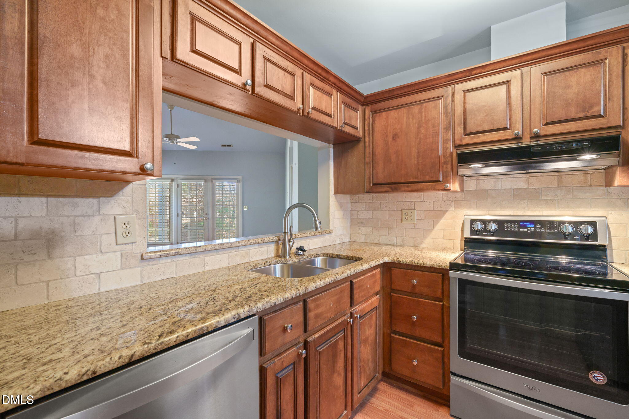1212 Berley Court Raleigh, NC 27609 - Photo 13 of 38 a kitchen with granite countertop stainless steel appliances a stove sink and cabinets