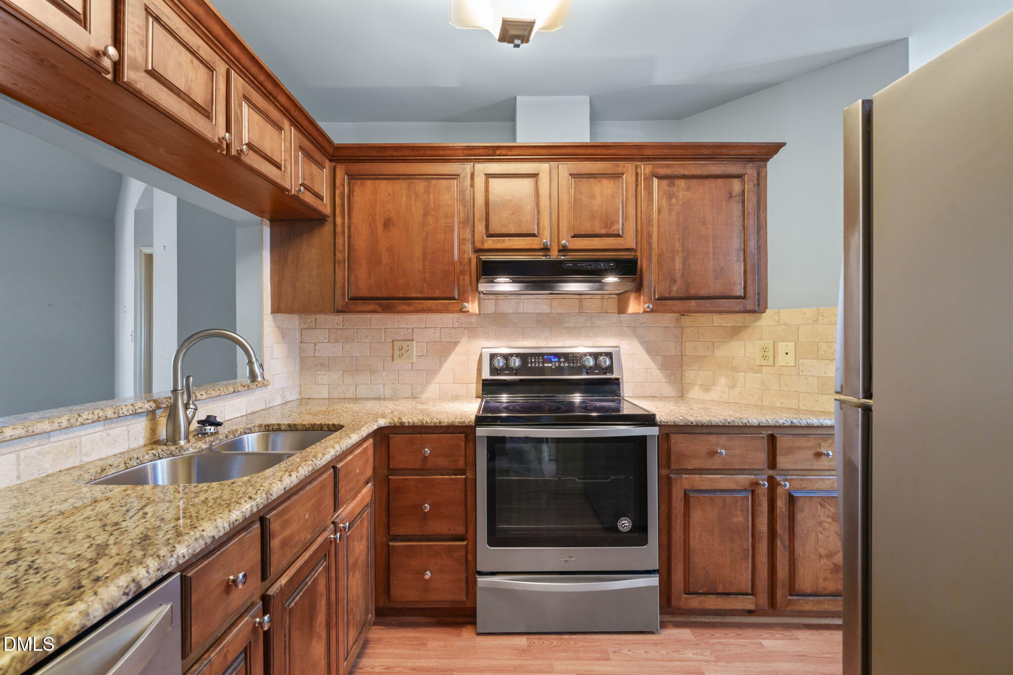 1212 Berley Court Raleigh, NC 27609 - Photo 14 of 38 a kitchen with stainless steel appliances granite countertop a sink stove and cabinets