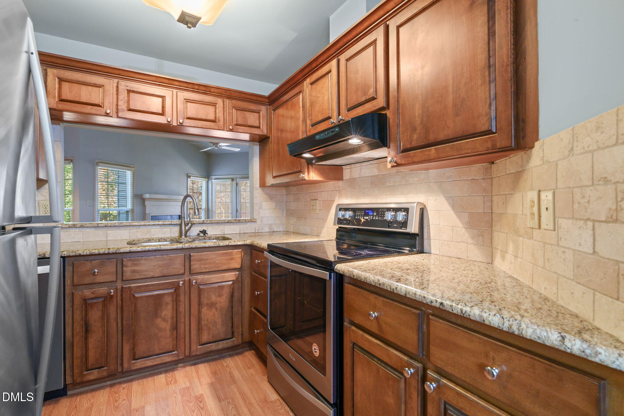 1212 Berley Court Raleigh, NC 27609 - Photo 15 of 38 a kitchen with stainless steel appliances granite countertop a sink stove and cabinets