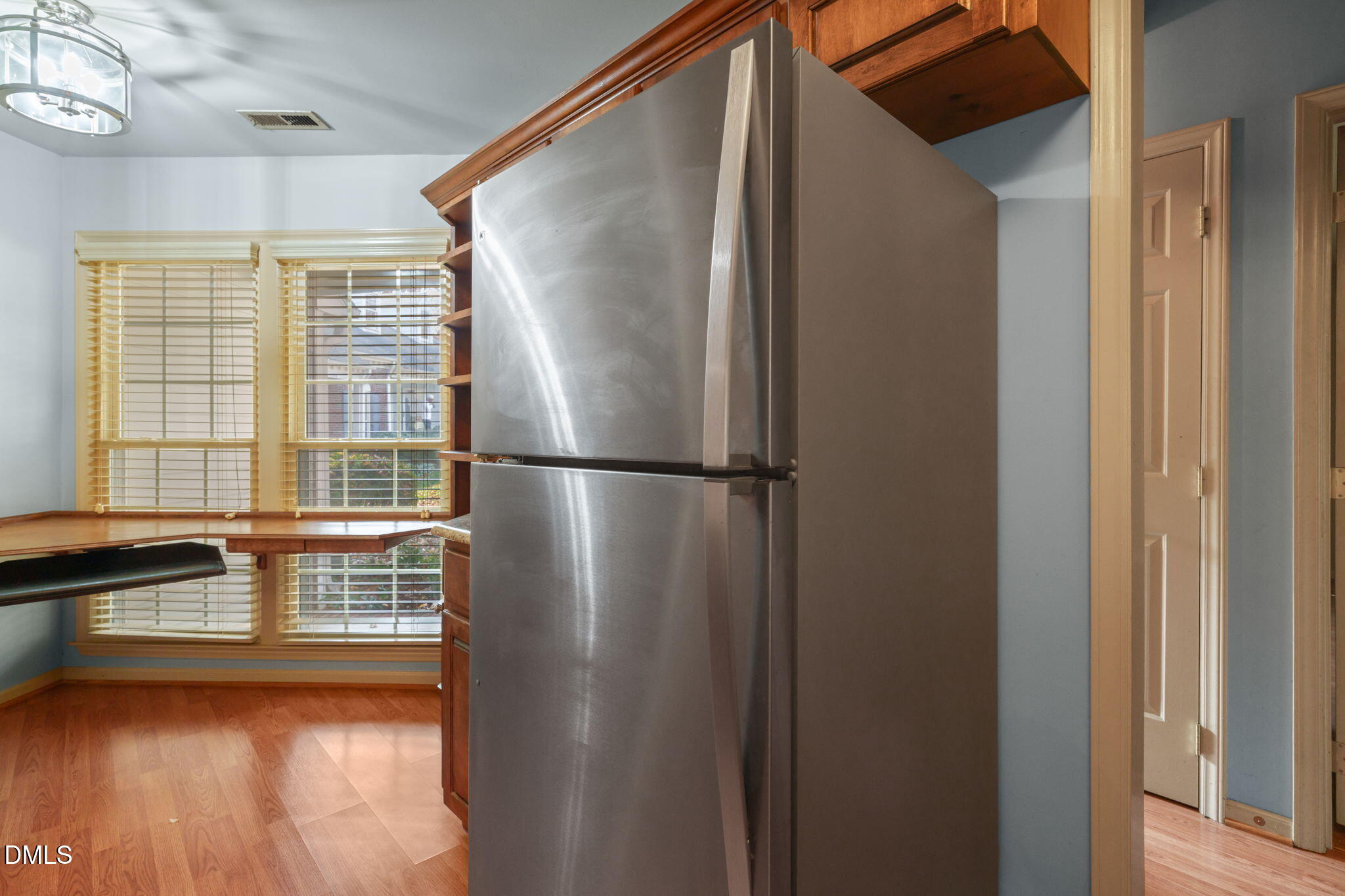 1212 Berley Court Raleigh, NC 27609 - Photo 17 of 38 a view of walk in closet with wooden floor