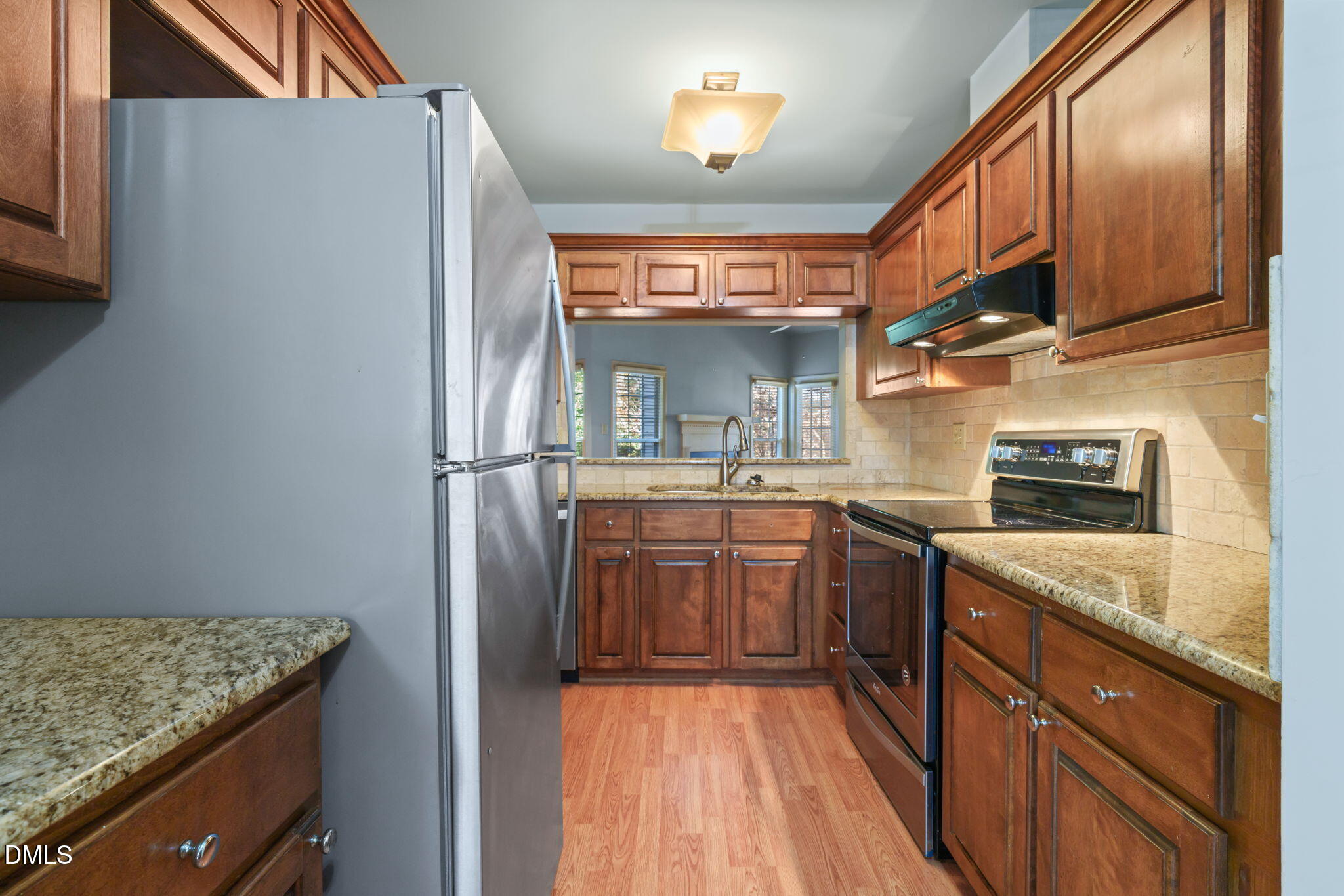 1212 Berley Court Raleigh, NC 27609 - Photo 18 of 38 a kitchen with stainless steel appliances granite countertop a refrigerator and a sink