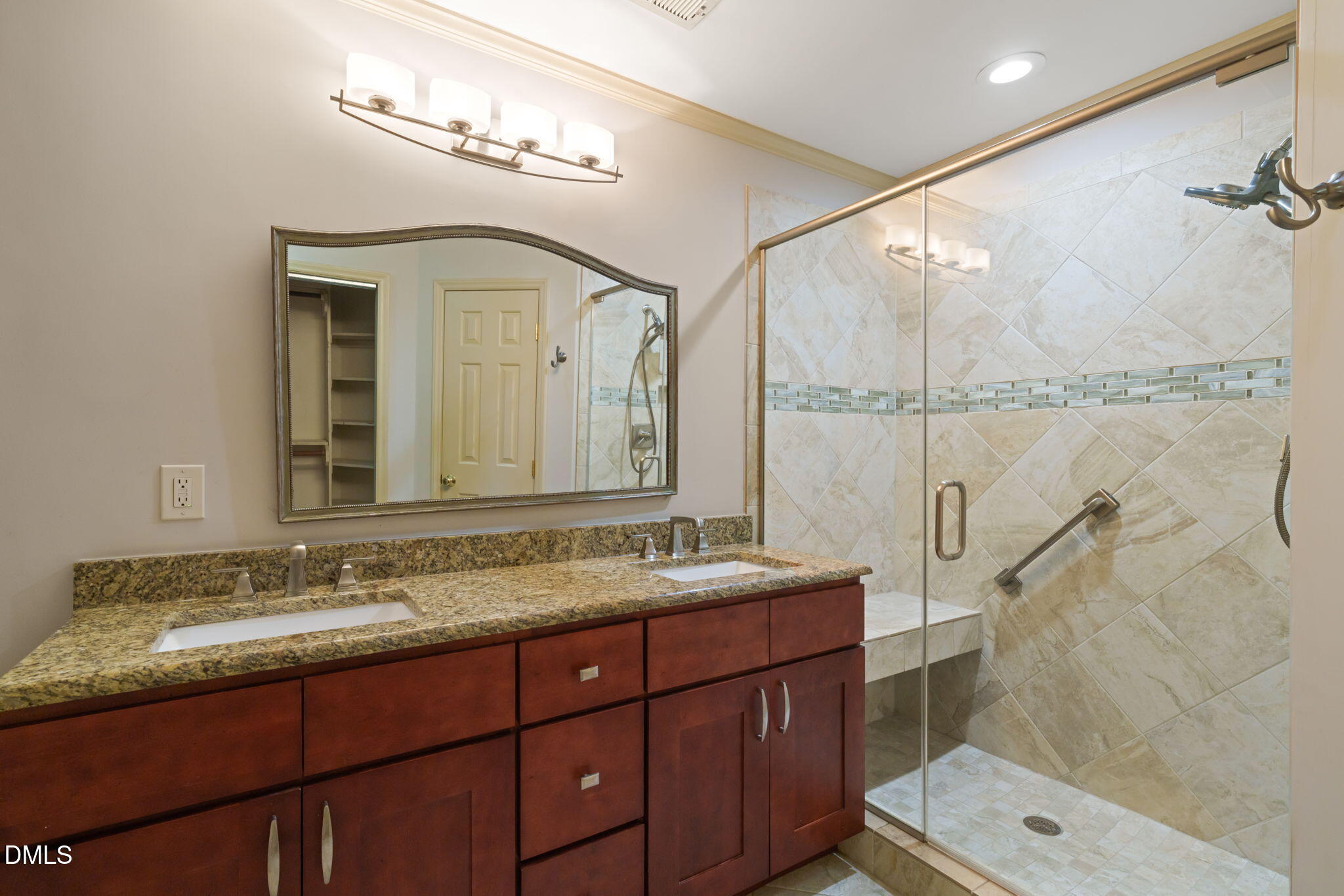 1212 Berley Court Raleigh, NC 27609 - Photo 24 of 38 a bathroom with a double vanity sink and mirror with shower