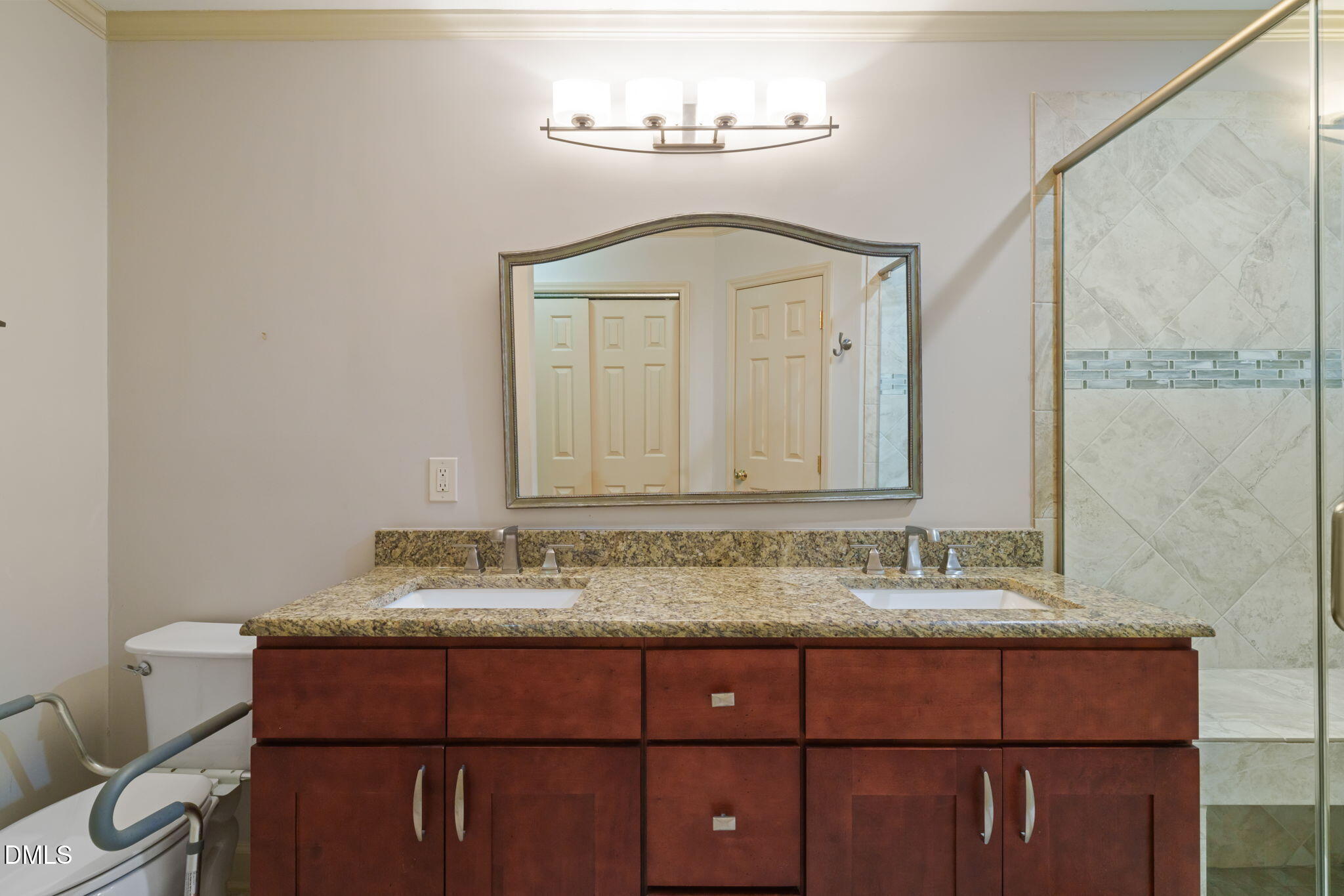 1212 Berley Court Raleigh, NC 27609 - Photo 25 of 38 a bathroom with a sink vanity and a mirror