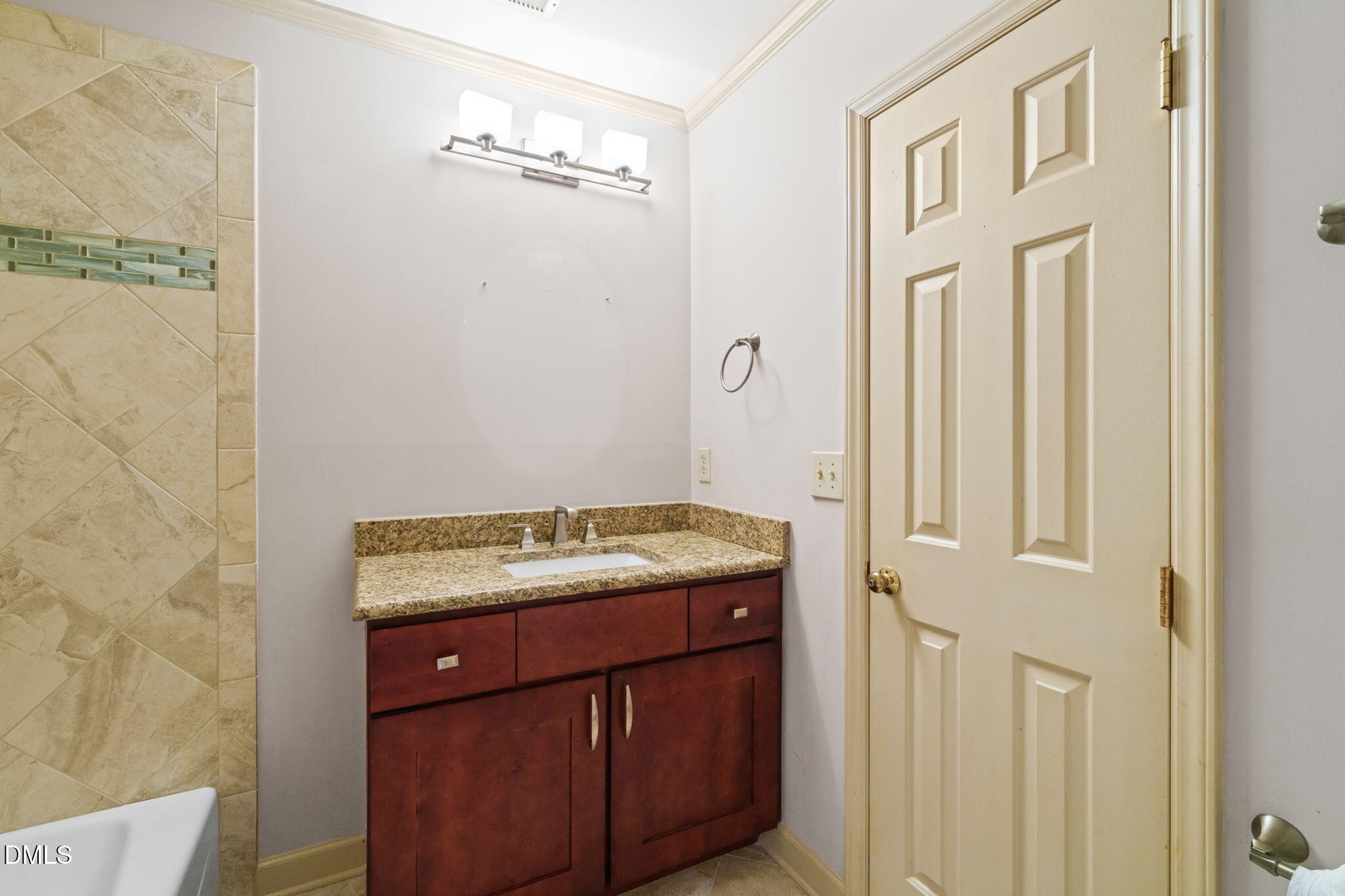 1212 Berley Court Raleigh, NC 27609 - Photo 30 of 38 a bathroom with a granite countertop sink and a mirror