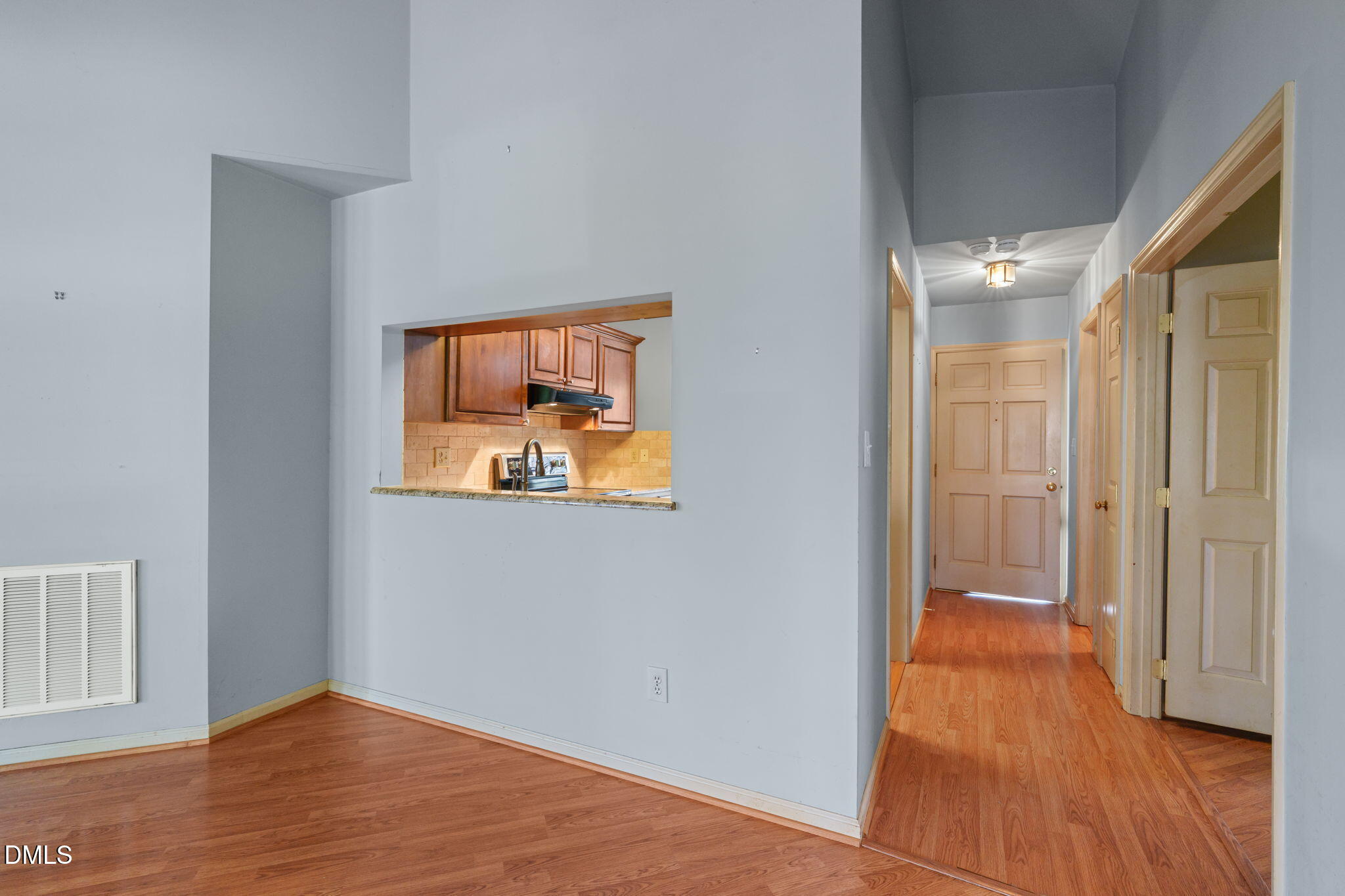 1212 Berley Court Raleigh, NC 27609 - Photo 3 of 38 a view of a hallway with wooden floor