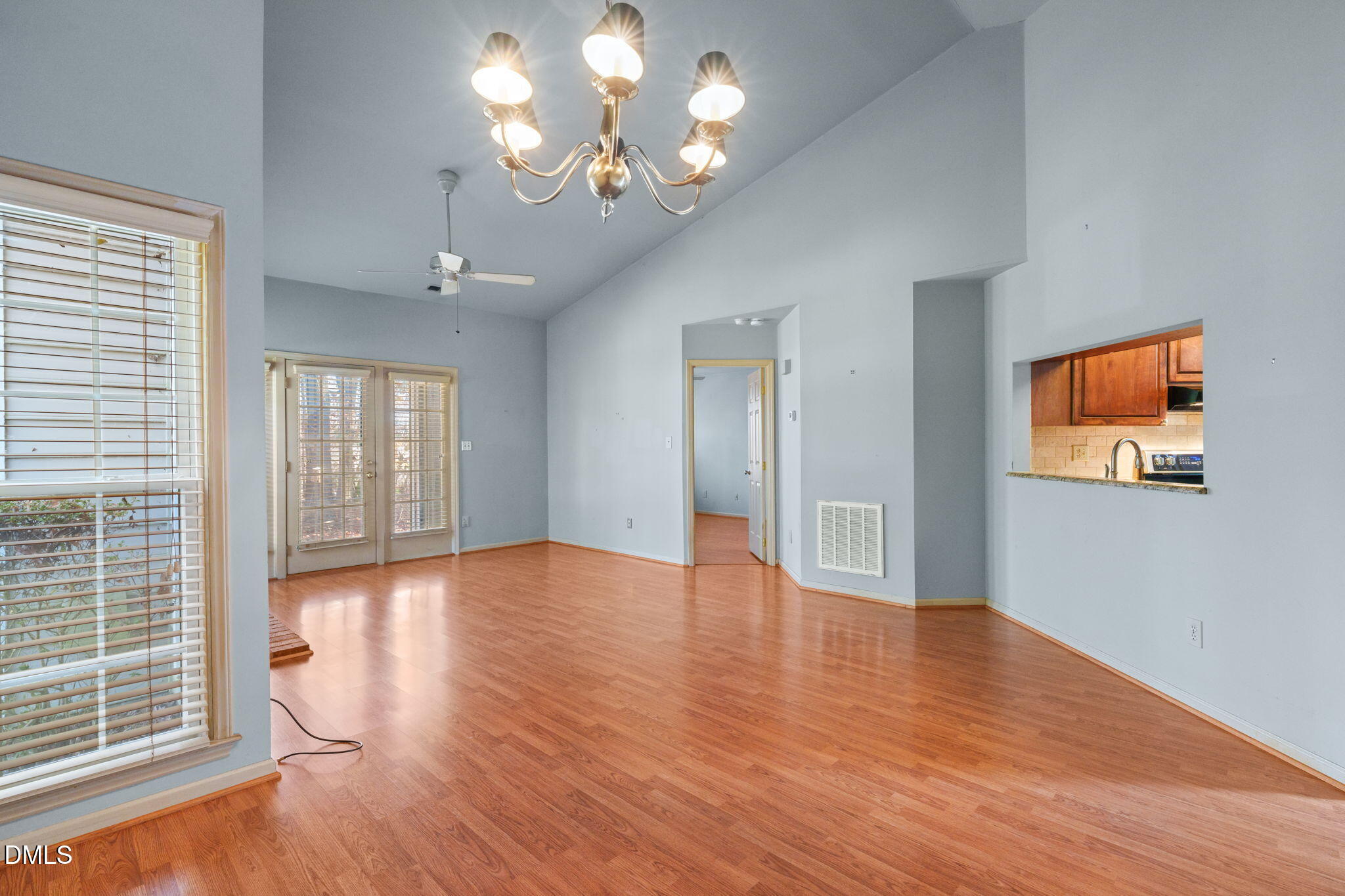 1212 Berley Court Raleigh, NC 27609 - Photo 4 of 38 a view of an empty room with wooden floor and a window