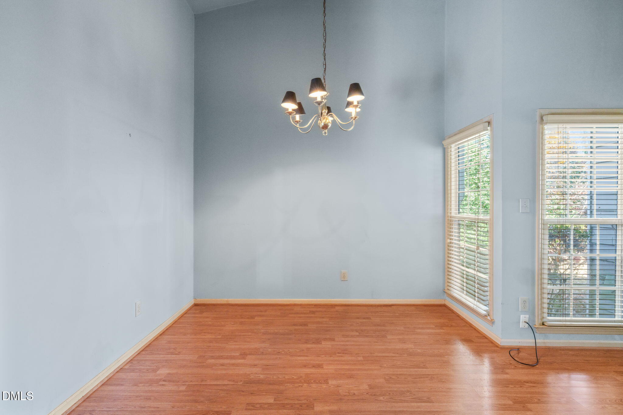 1212 Berley Court Raleigh, NC 27609 - Photo 5 of 38 a view of an empty room with wooden floor and a window