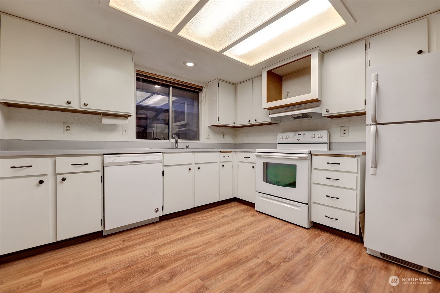 17206 30th Drive Southeast Bothell, WA 98012 - Photo 7 of 40 a kitchen with white cabinets stainless steel appliances and sink