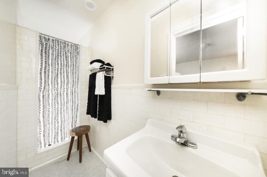 1229 Chestnut Street, Unit 402 Philadelphia, PA 19107 - Photo 20 of 21 a bathroom with a sink and mirror