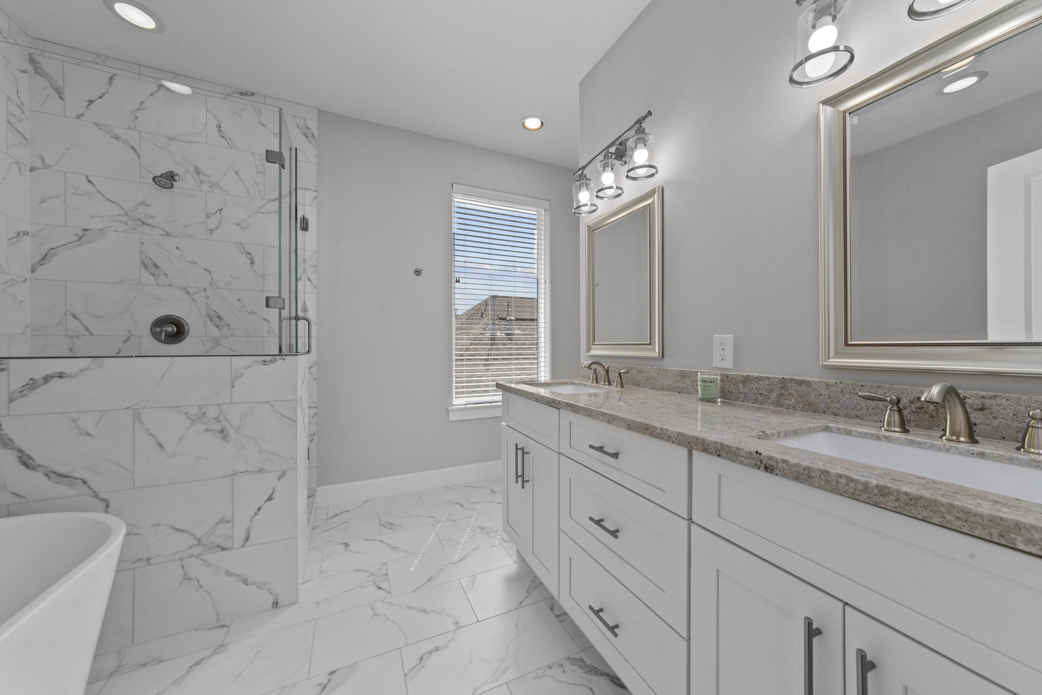 623 Link Road Houston, TX 77009 - Photo 12 of 25 a bathroom with a granite countertop sink a toilet a mirror and shower