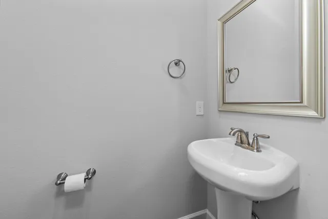 a bathroom with a sink and mirror
