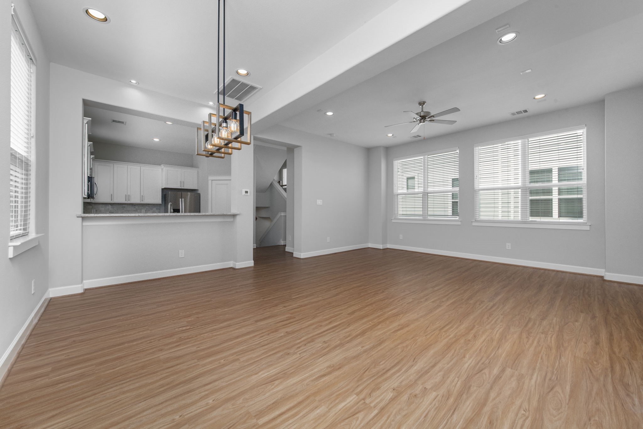 623 Link Road Houston, TX 77009 - Photo 3 of 25 a view of a kitchen and an empty room with wooden floor and a kitchen