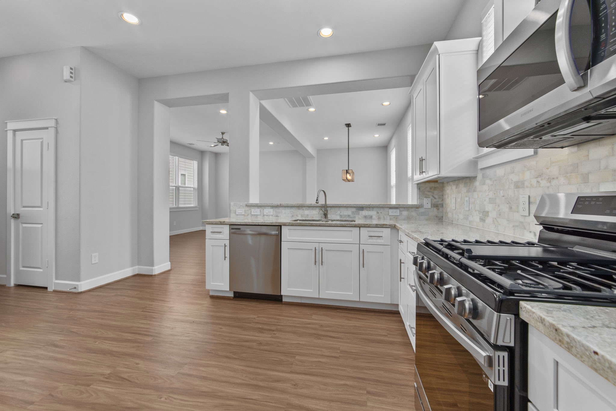 623 Link Road Houston, TX 77009 - Photo 4 of 25 a kitchen with a stove a sink and a refrigerator