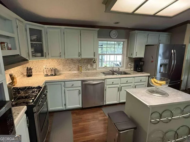 a kitchen with a sink stove and refrigerator