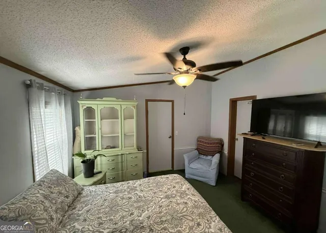 a bedroom with a bed and a television