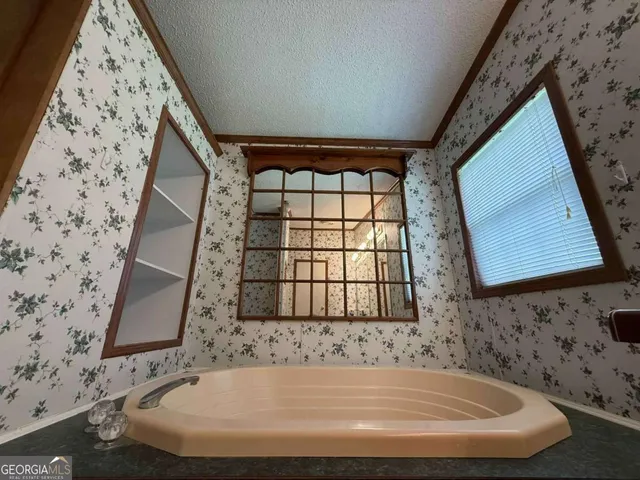 a bath tub sitting in a bathroom next to a window