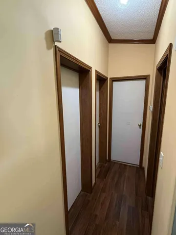 a view of hallway with wooden floor