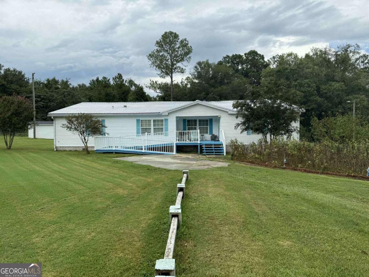 289 Mason Dixon Line Road, Unit 3 Ashburn, GA 31714 - Photo 2 of 32 a view of a house with a swimming pool