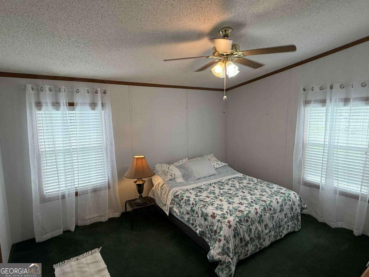 289 Mason Dixon Line Road, Unit 3 Ashburn, GA 31714 - Photo 22 of 32 a bedroom with a bed and a window