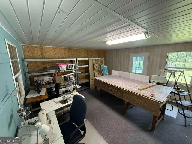 a bedroom with furniture a bed and a large window