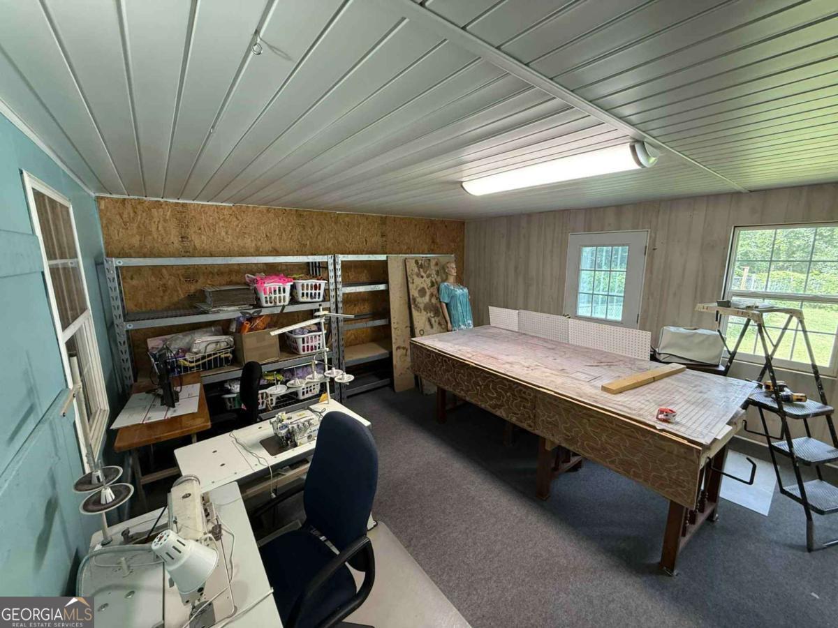 289 Mason Dixon Line Road, Unit 3 Ashburn, GA 31714 - Photo 29 of 32 a bedroom with furniture a bed and a large window