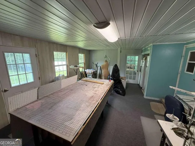 a room with pool table and windows