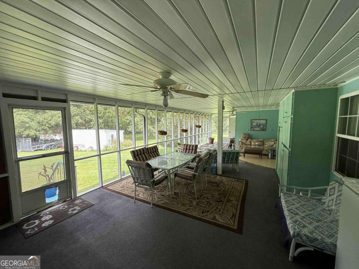 289 Mason Dixon Line Road, Unit 3 Ashburn, GA 31714 - Photo 31 of 32 a living room with furniture and a large window