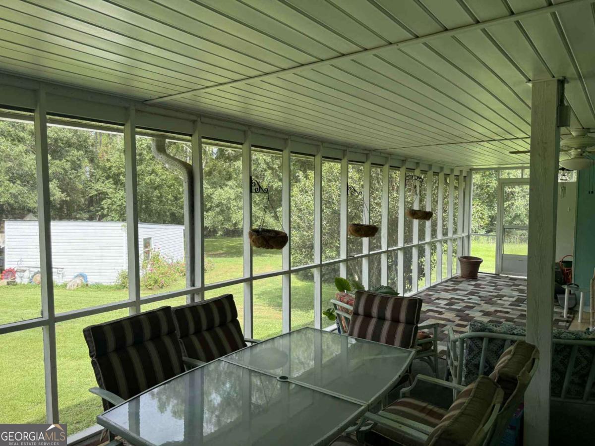 289 Mason Dixon Line Road, Unit 3 Ashburn, GA 31714 - Photo 32 of 32 a balcony with furniture