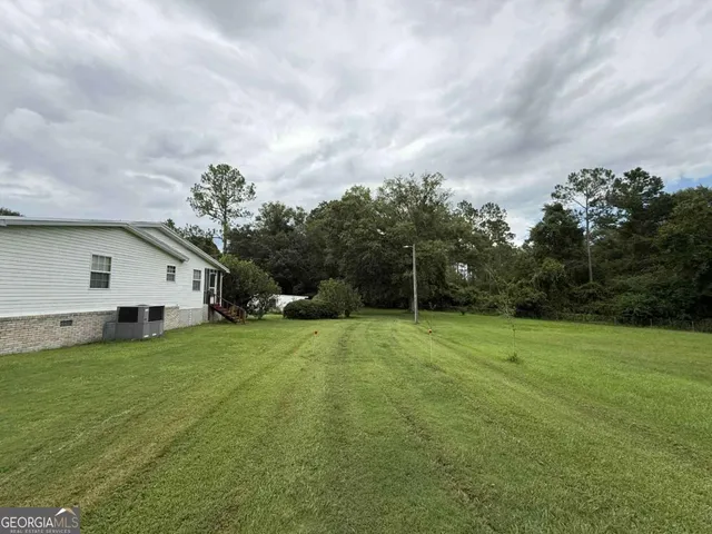 a view of a backyard of the house