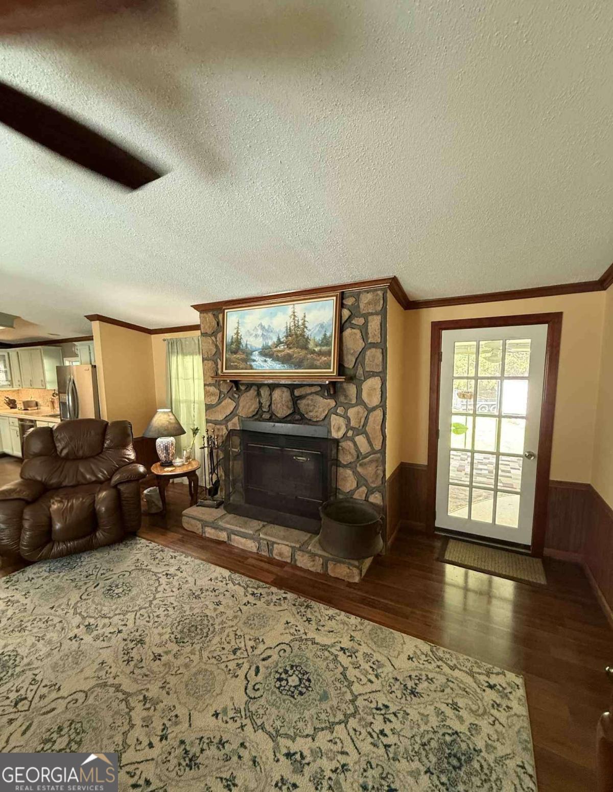 289 Mason Dixon Line Road, Unit 3 Ashburn, GA 31714 - Photo 7 of 32 a living room with furniture a fireplace and a flat screen tv