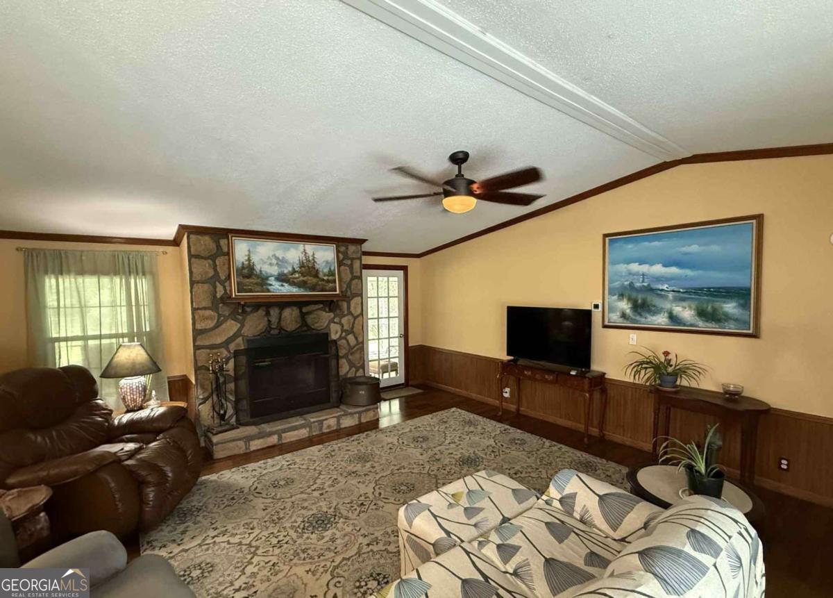 289 Mason Dixon Line Road, Unit 3 Ashburn, GA 31714 - Photo 8 of 32 a living room with furniture and a flat screen tv