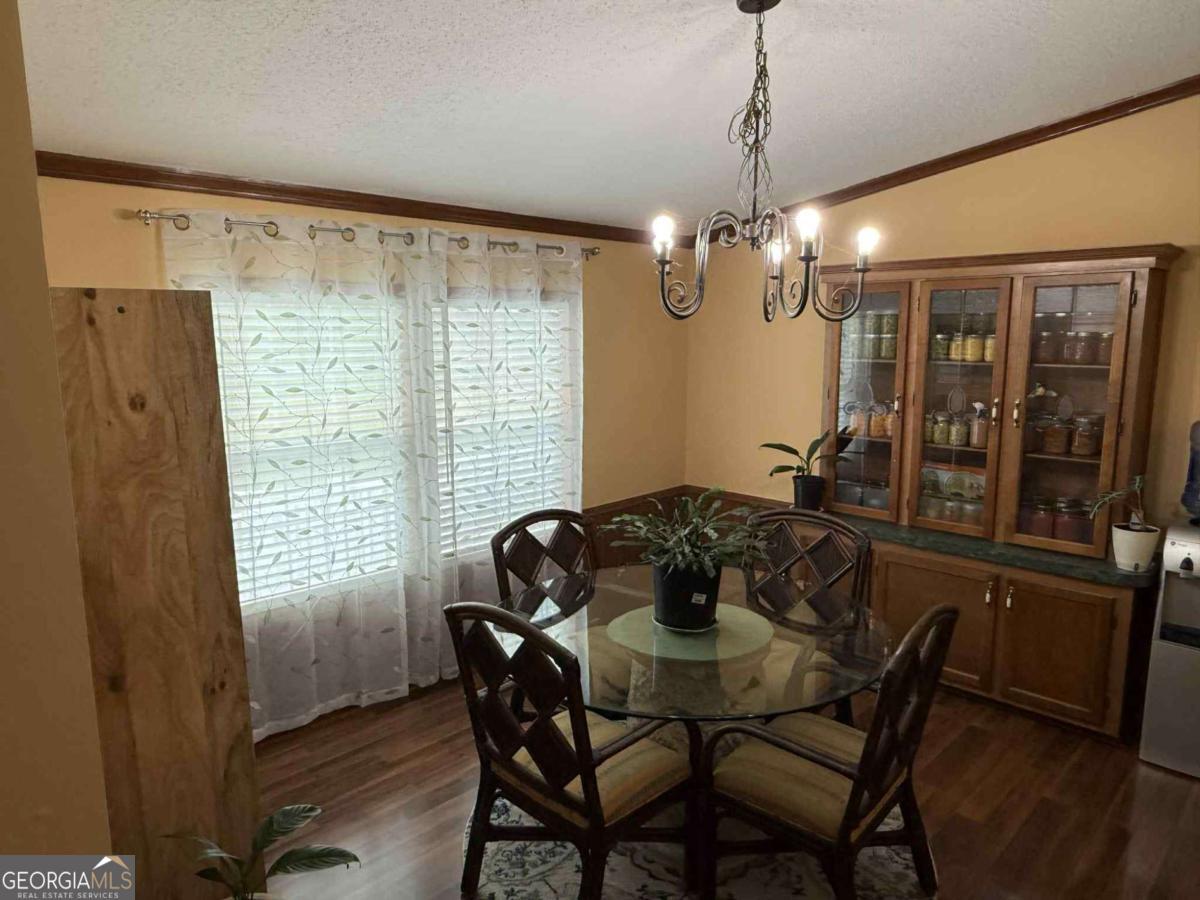 289 Mason Dixon Line Road, Unit 3 Ashburn, GA 31714 - Photo 10 of 32 a dining room with furniture and window