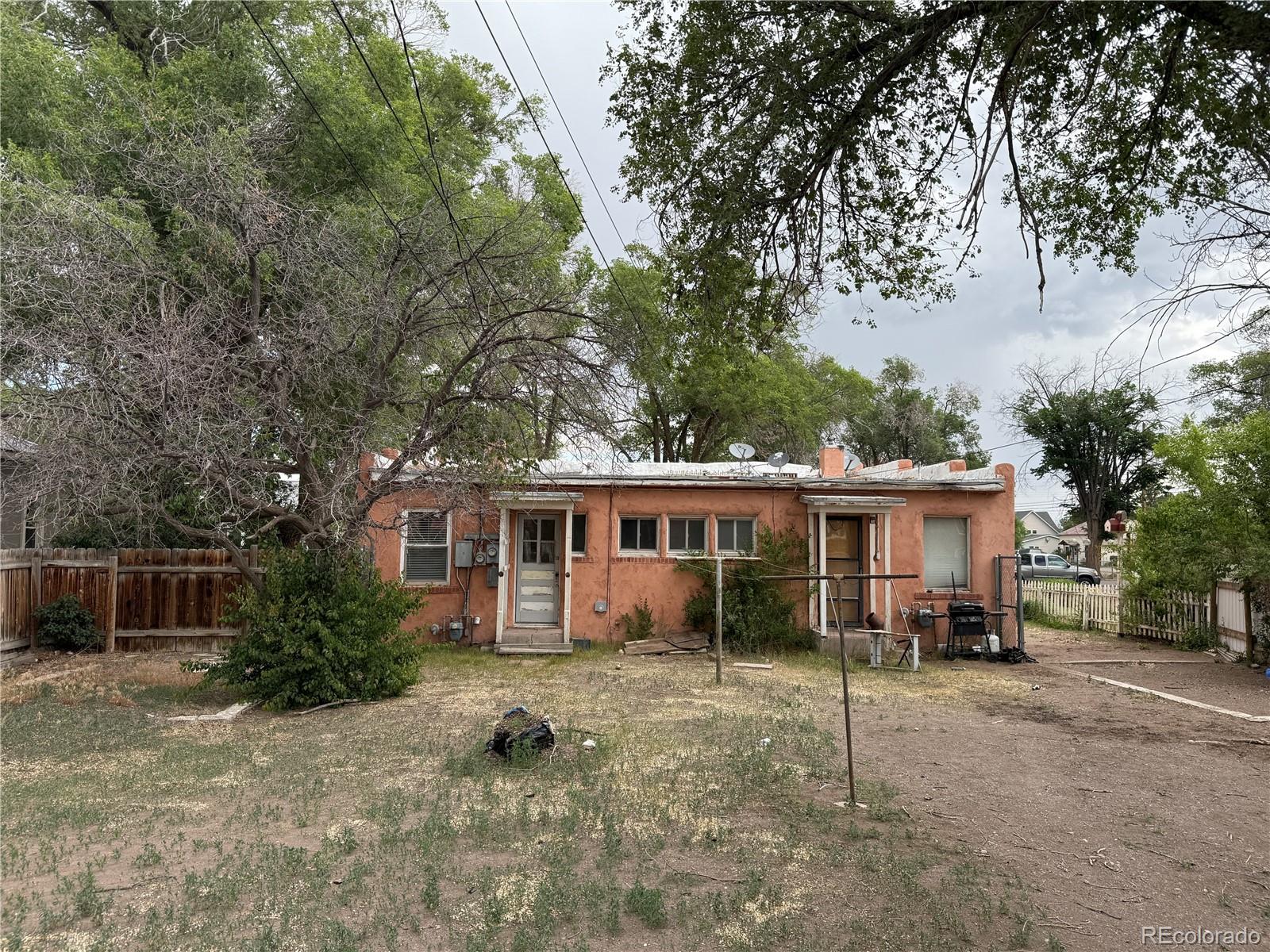 134 West 3rd Street Center, CO 81125 - Photo 11 of 13 a view of a house with backyard and a tree