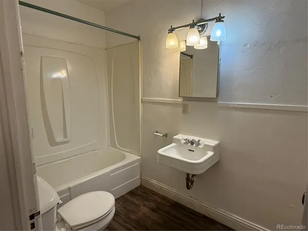 a bathroom with a toilet a sink and bathtub