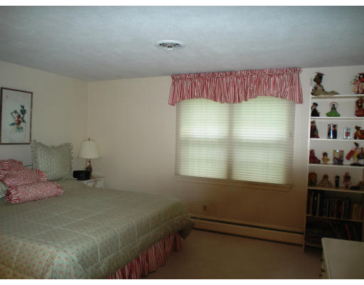 141 Worthen Road Lexington, MA 02421 - Photo 16 of 21 a bedroom with a bed and a window