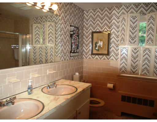 141 Worthen Road Lexington, MA 02421 - Photo 17 of 21 a bathroom with a sink and a mirror