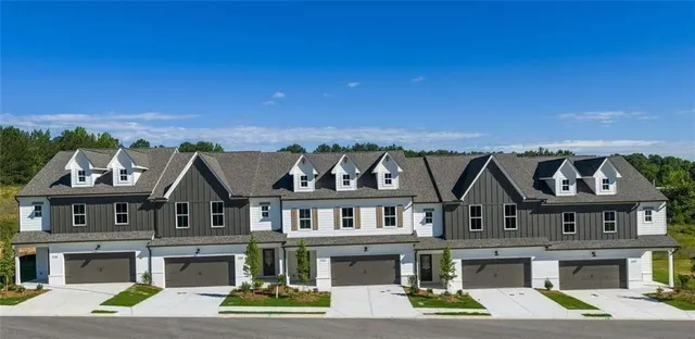 a aerial view of a house with a big yard and large trees
