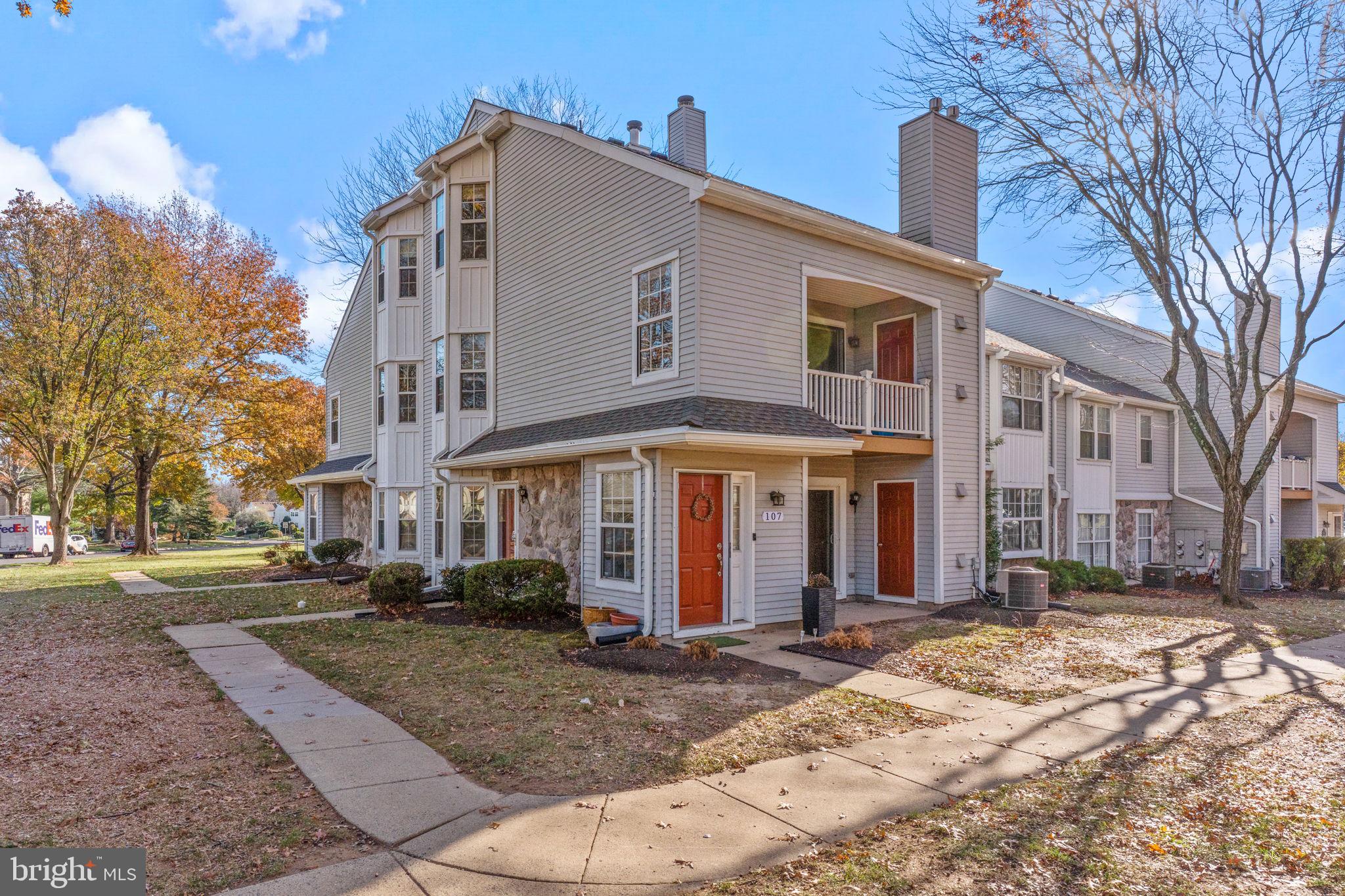 a front view of a building with a yard