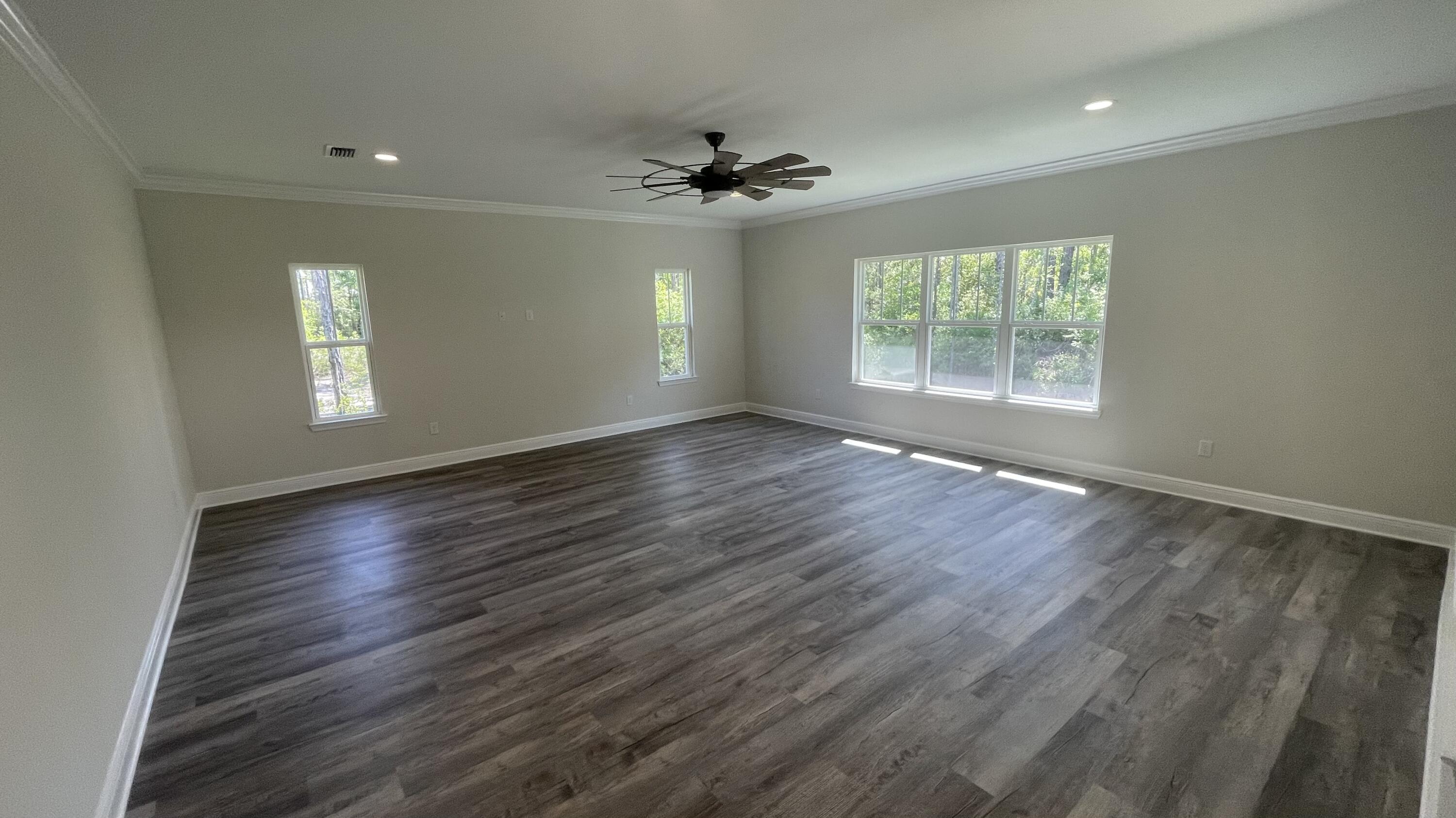 116 Bear Creek Boulevard Freeport, FL 32439 - Photo 3 of 16 a view of an empty room with wooden floor and a window