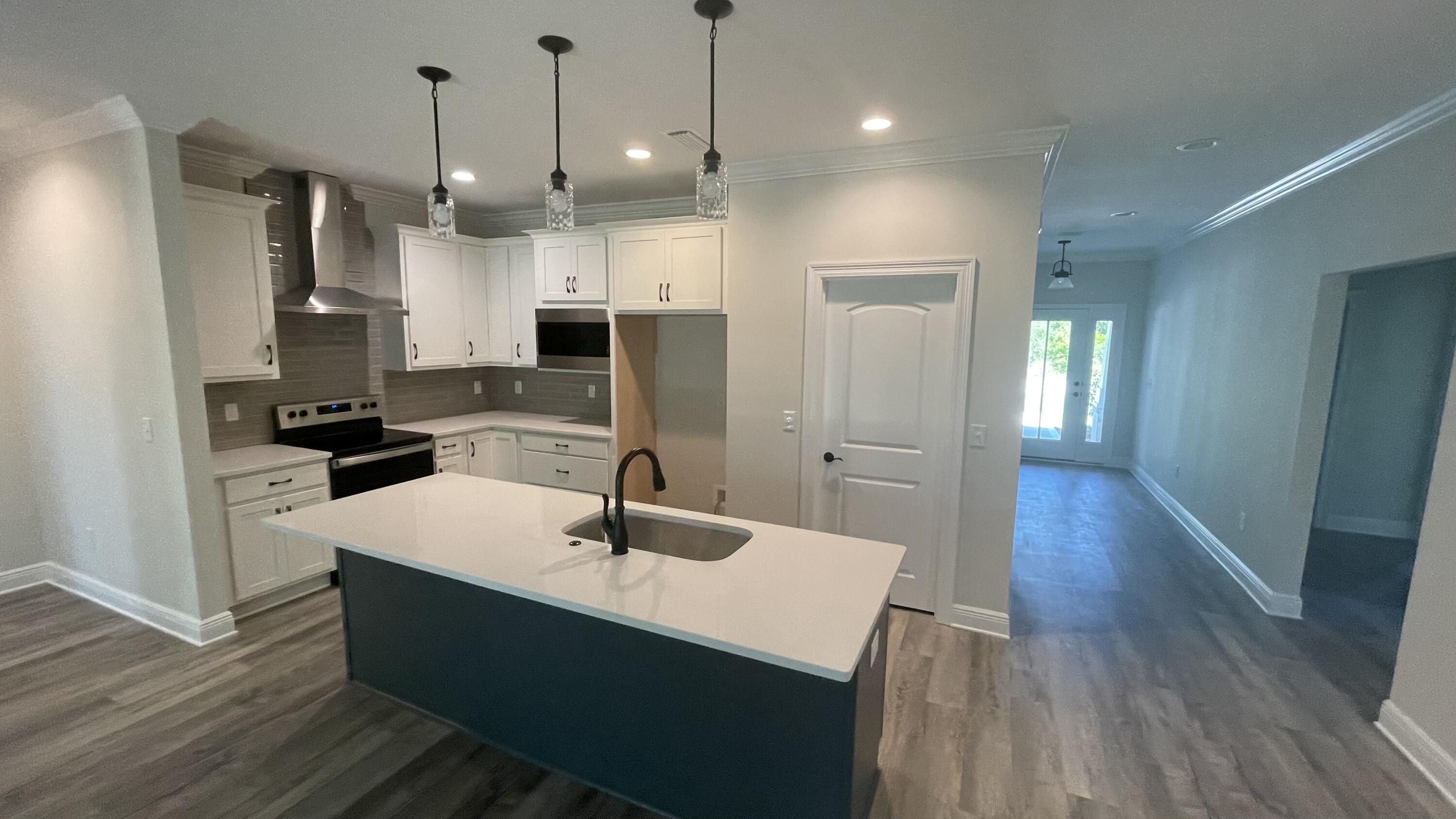 116 Bear Creek Boulevard Freeport, FL 32439 - Photo 4 of 16 a kitchen with stainless steel appliances a refrigerator a sink a stove a microwave and wooden floor
