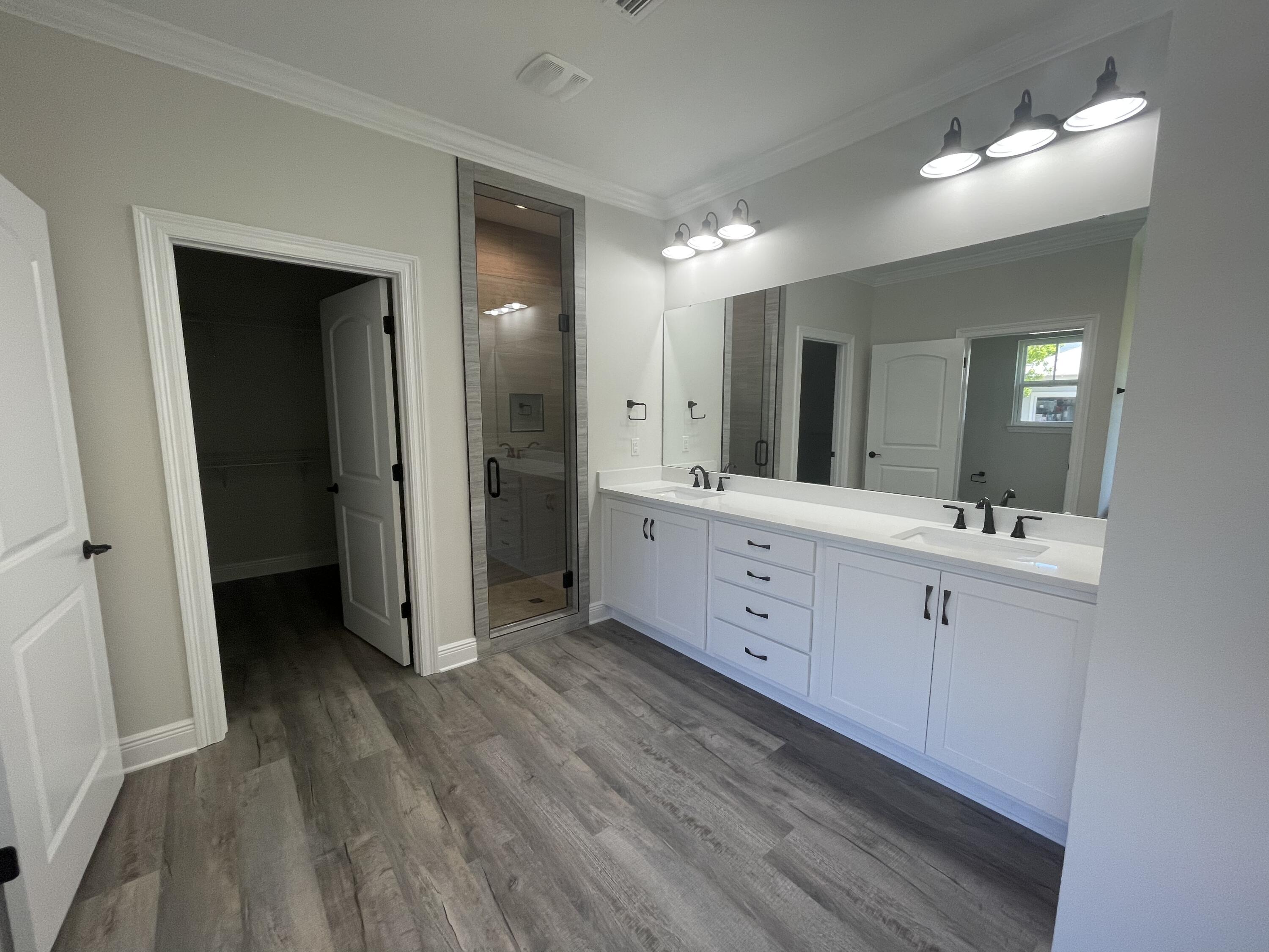 116 Bear Creek Boulevard Freeport, FL 32439 - Photo 6 of 16 a spacious bathroom with a double vanity sink and a mirror
