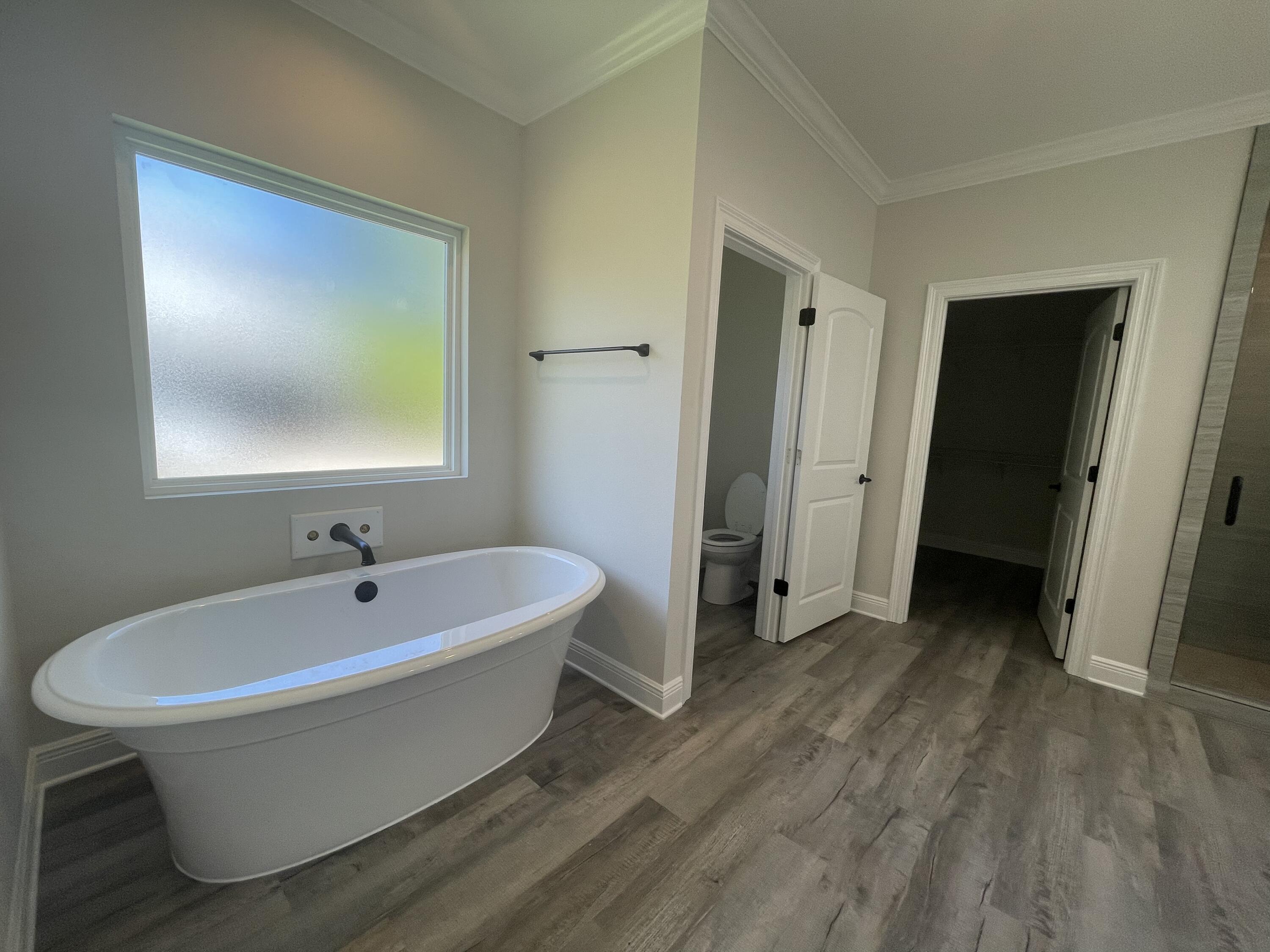 116 Bear Creek Boulevard Freeport, FL 32439 - Photo 8 of 16 a white bath tub sitting in a bathroom